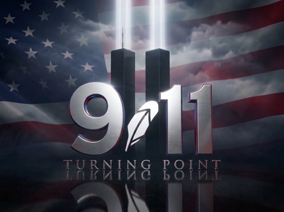 Silver 9.11 Turning Point emblem with a feather, twin beams and an American flag behind